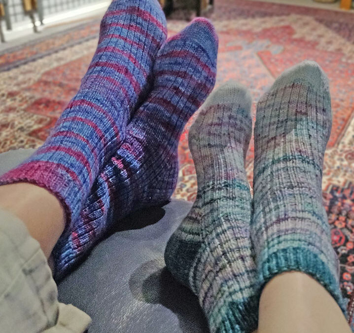 Two pairs of socks knitted according to the pattern given here, shown on my feet and my husband's